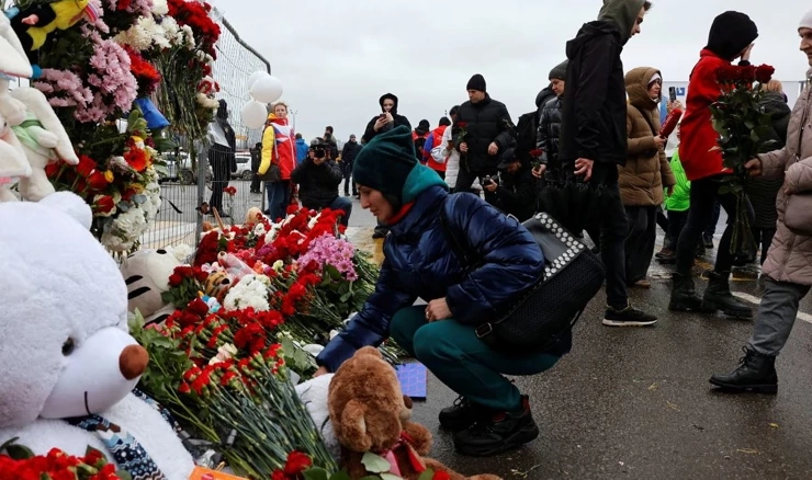 Ljudi ostavljaju cvijeće na mjesto jučerašnje tragedije u koncertnoj dvorani blizu Moskve