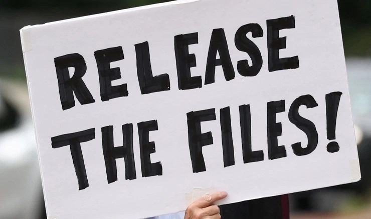 Prosvjednik drži transparent "Objavite zapise" u vezi Epsteinovih dosjea